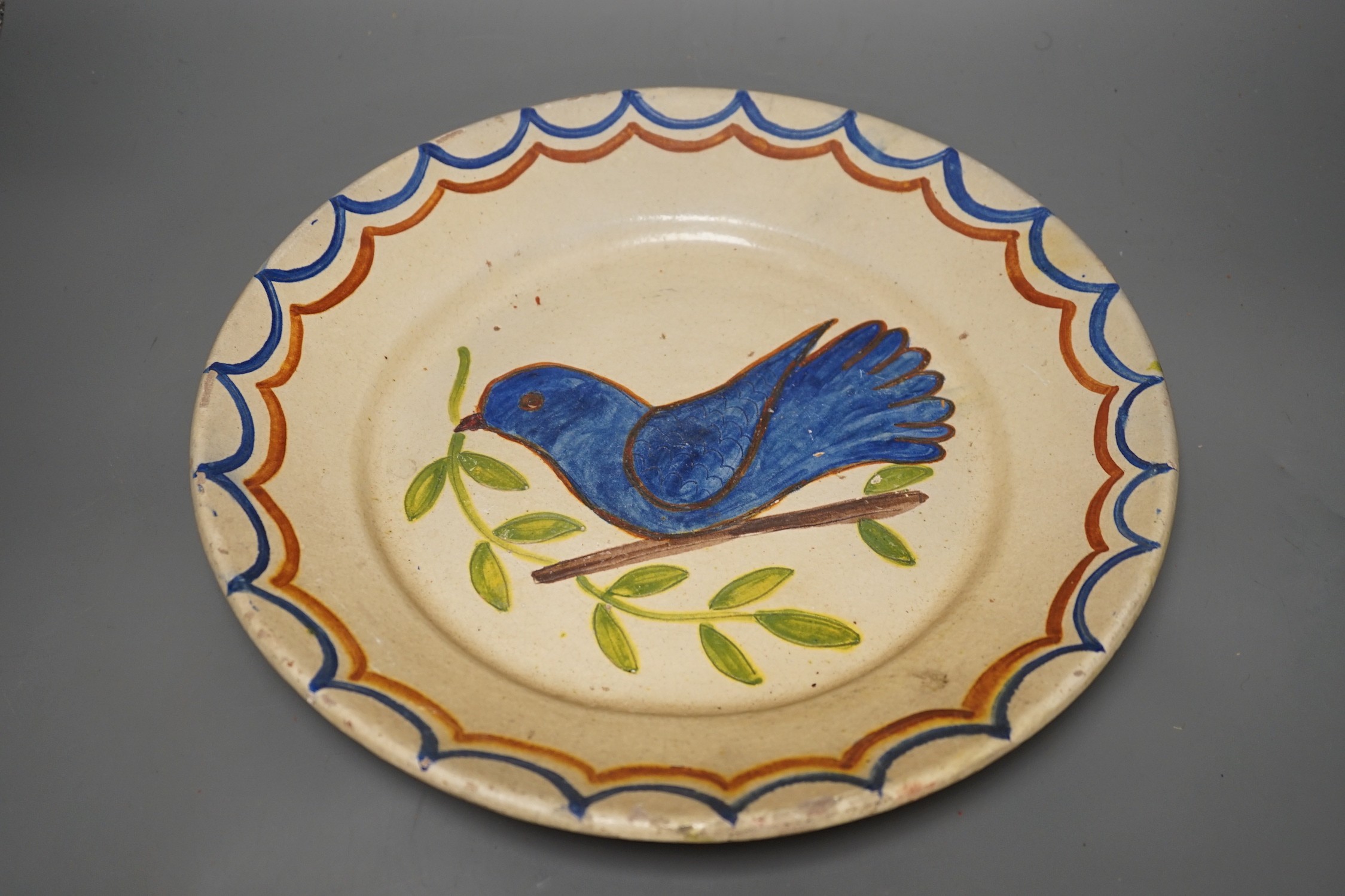 Five Portuguese provincial pottery plates, largest 35 cms diameter